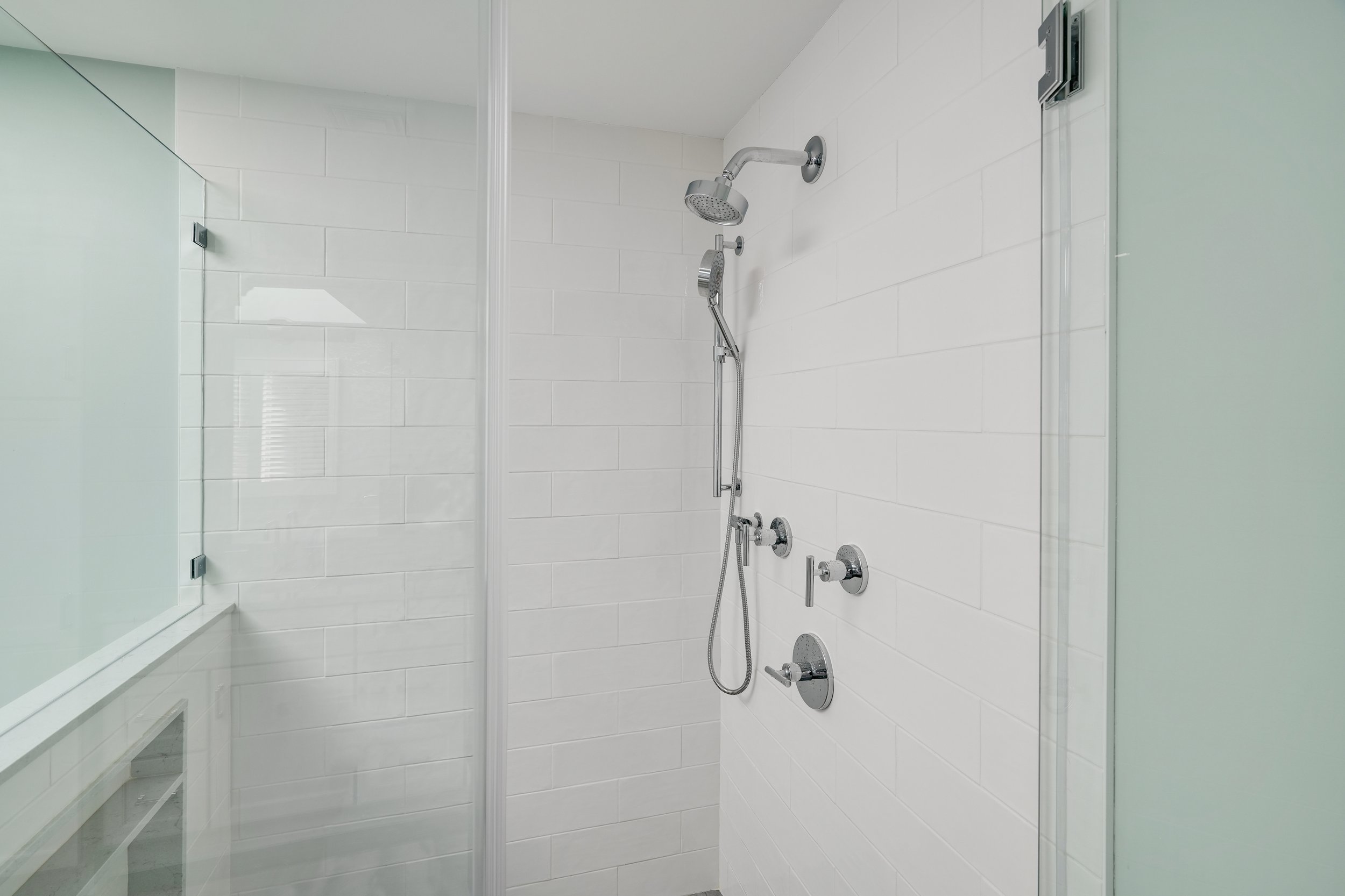 Primary bathroom, double under mount sink, glass shower, soaking tub, mudroom, laundry room, charcoal floor tiles, galley bathroom, light and airy.