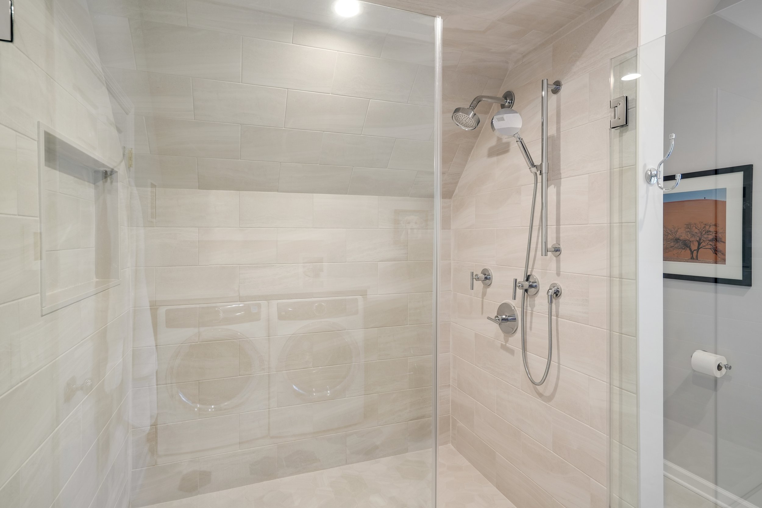 Primary bathroom, double under mount sink, glass shower, soaking tub, mudroom, laundry room, charcoal floor tiles, galley bathroom, light and airy.
