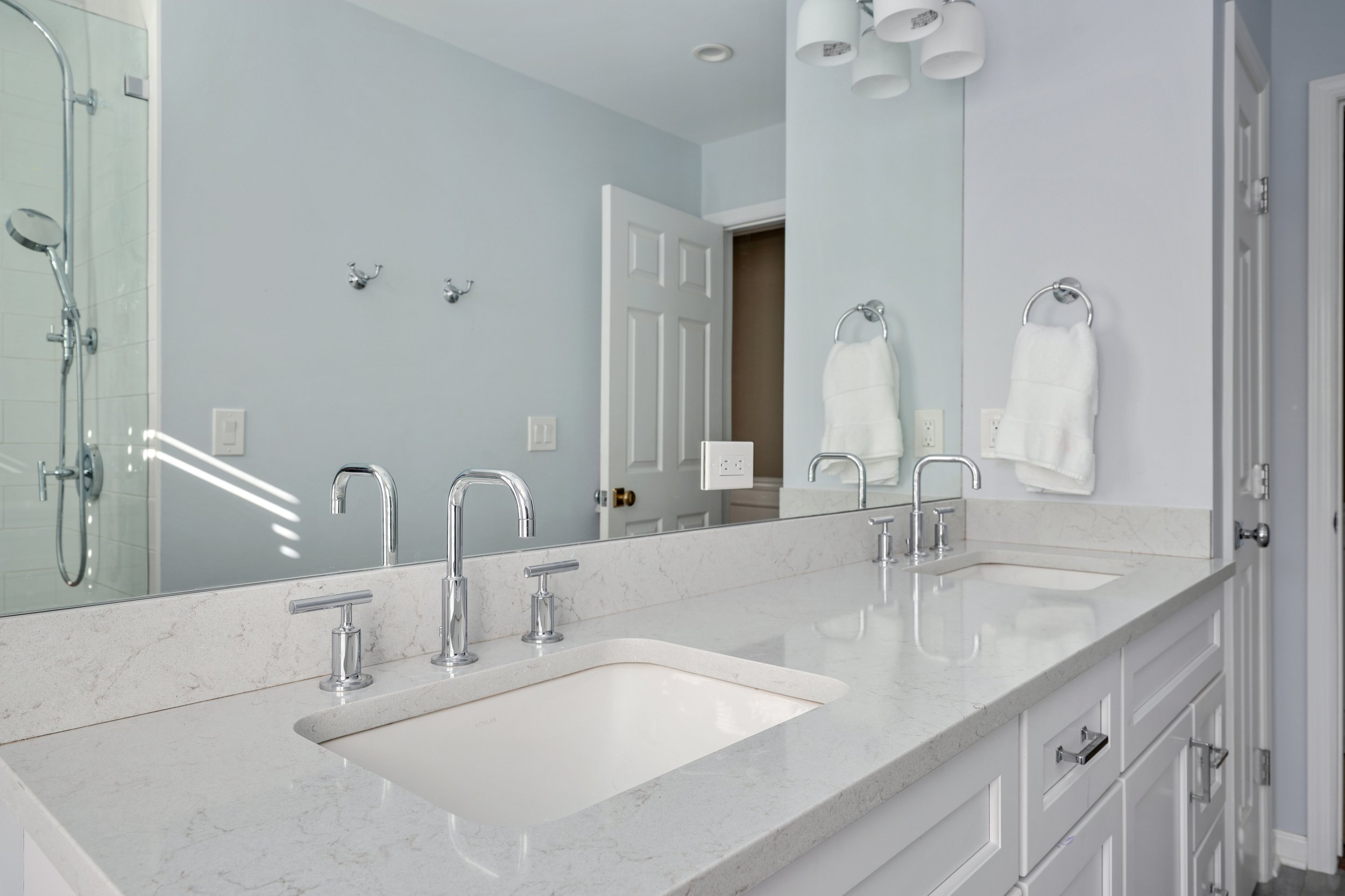 Primary bathroom, double under mount sink, glass shower, soaking tub, mudroom, laundry room, charcoal floor tiles, galley bathroom, light and airy.