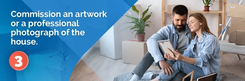 Tip 3: Commission artwork or a professional photograph of the house; a couple looks at a framed photo.
