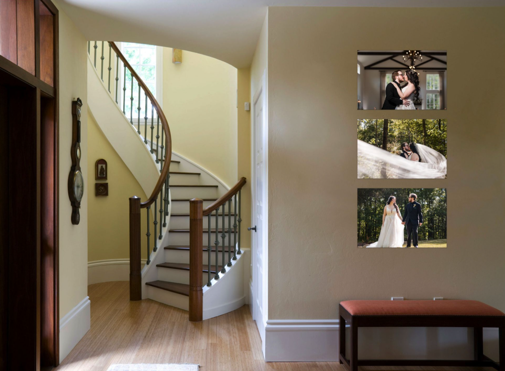 Interior view of a house with a staircase and three wedding photos on the wall.