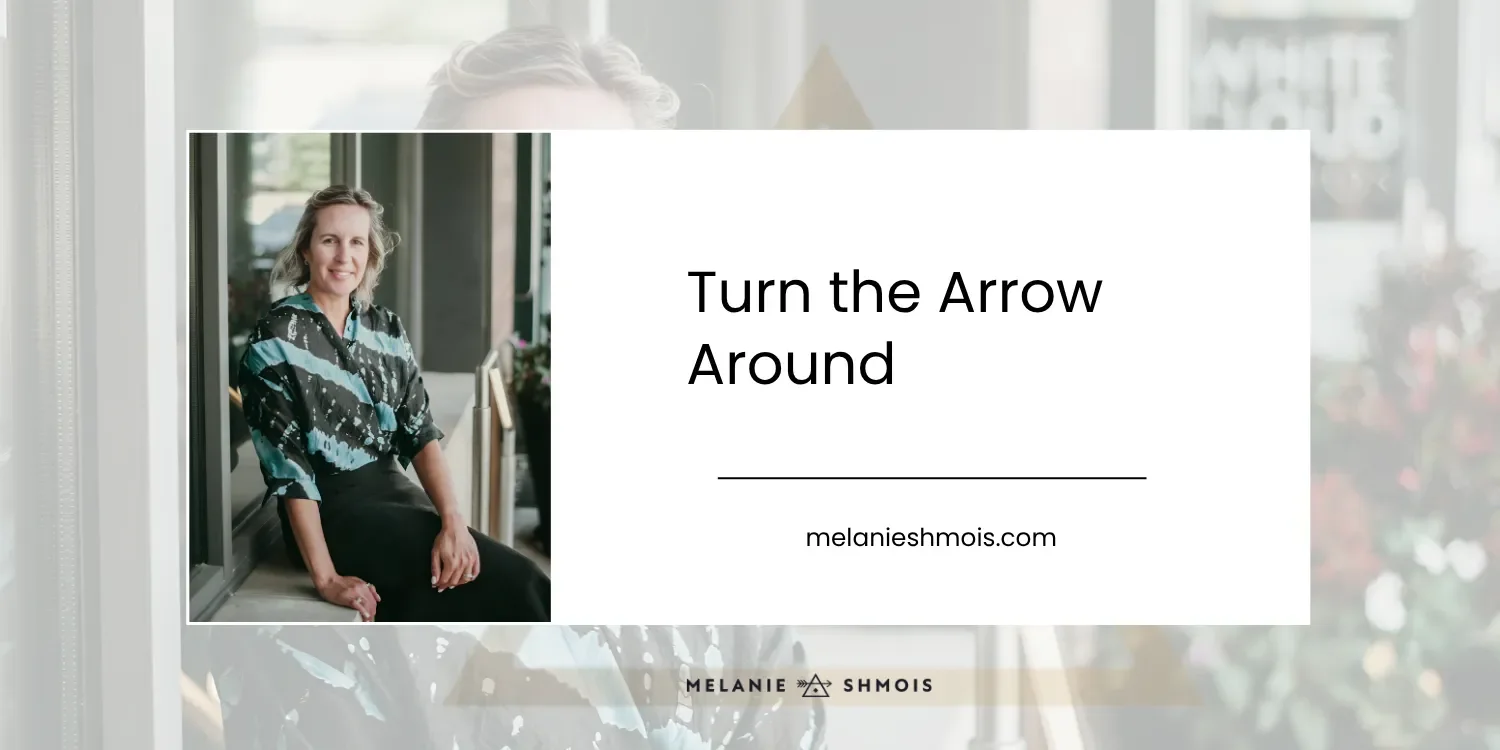 A photo of Melanie Shmois sitting on a ledge smiling, with the blog title: Turn the Arrow Around