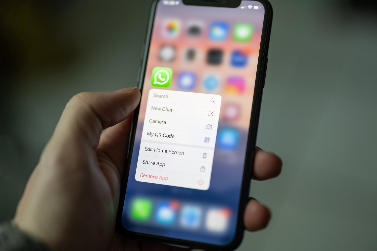 An image of someone deleting a social media app on their iPhone.