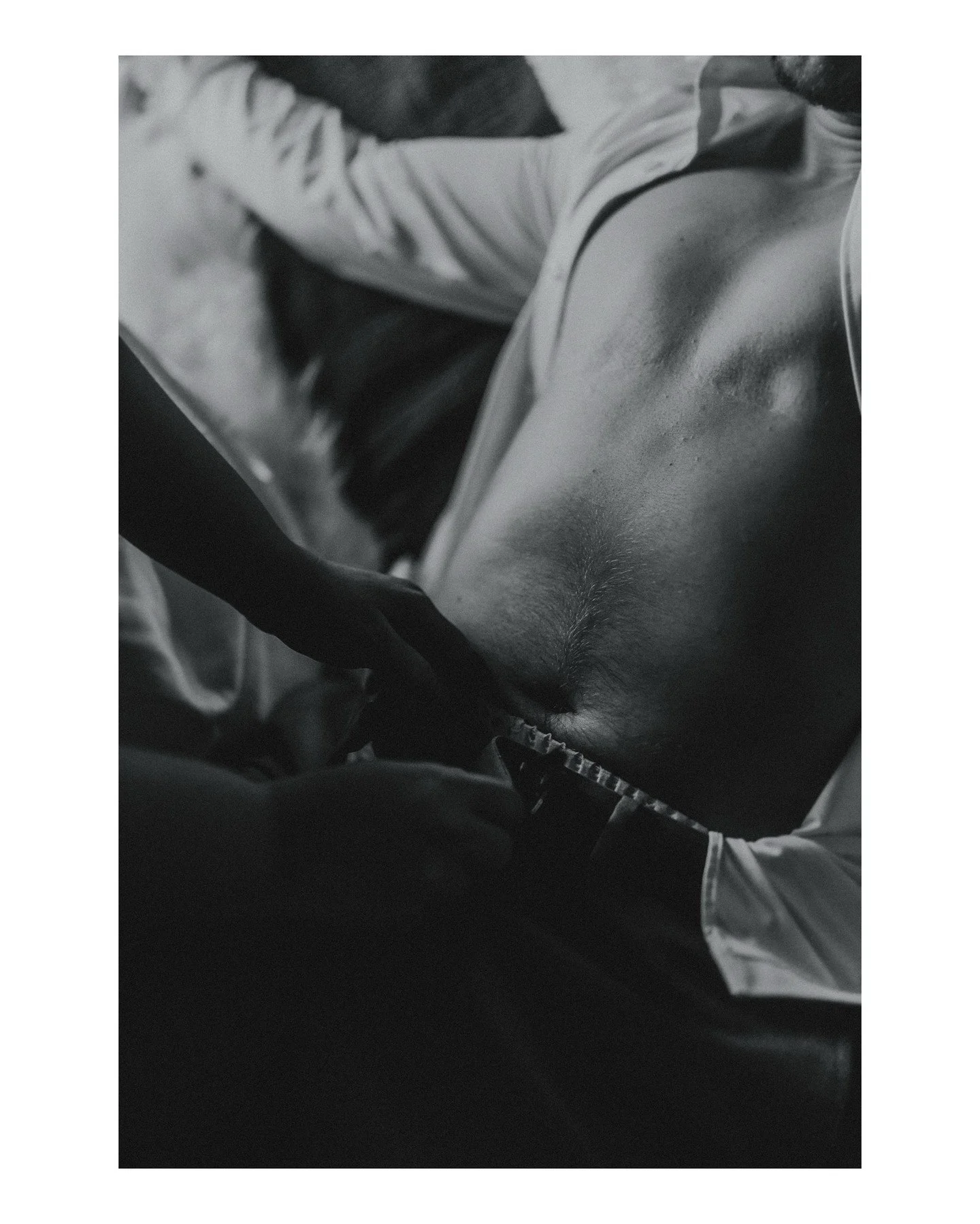 We love our trans friends, clients, and neighbors 'round these parts, ya hear? 💜🏳️&zwj;⚧️🏳️&zwj;🌈
.
.
.
.
.
.
[Image Description: A black &amp; white image of the chest of a trans man with a white dress shirt all the way unbuttoned, leaning back 