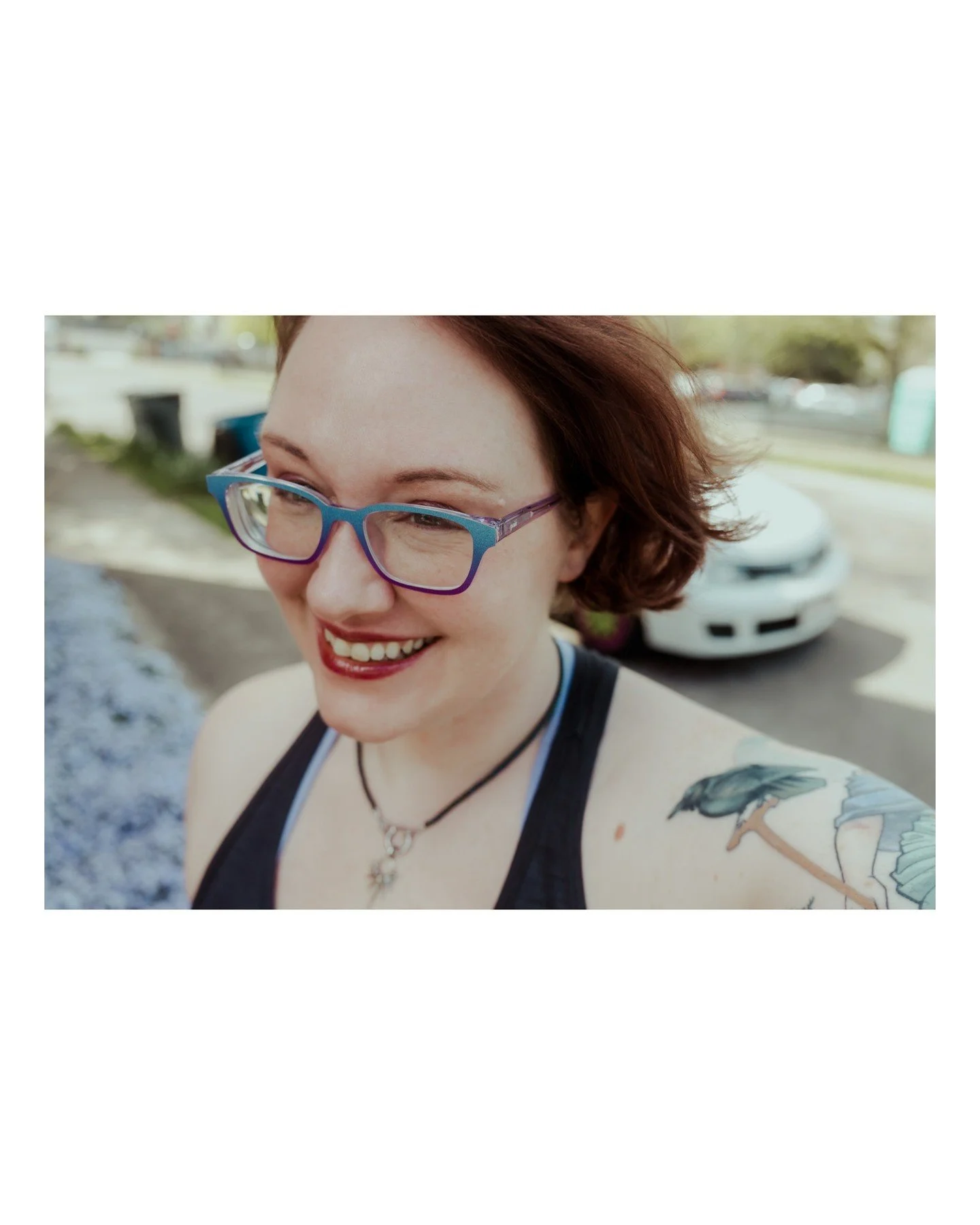 Still in love with this little Raven buddy that @theseboneshavefeelings put on my shoulder as a part of my Empress Tarot half-sleeve. 😍🐦&zwj;⬛💜
.
.
.
.
.
.
[Image Description: A white woman with short reddish brown hair and glasses is wearing a ta