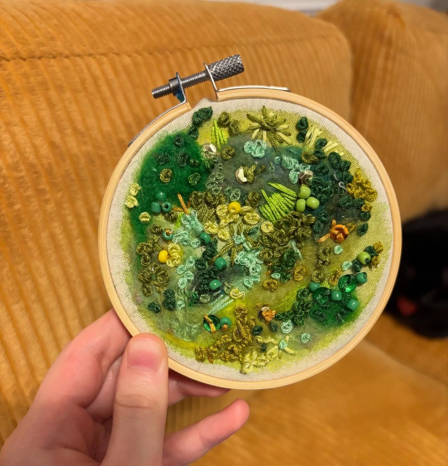 Moss (2025). Embroidery, wool roving, and beads on cloth. 