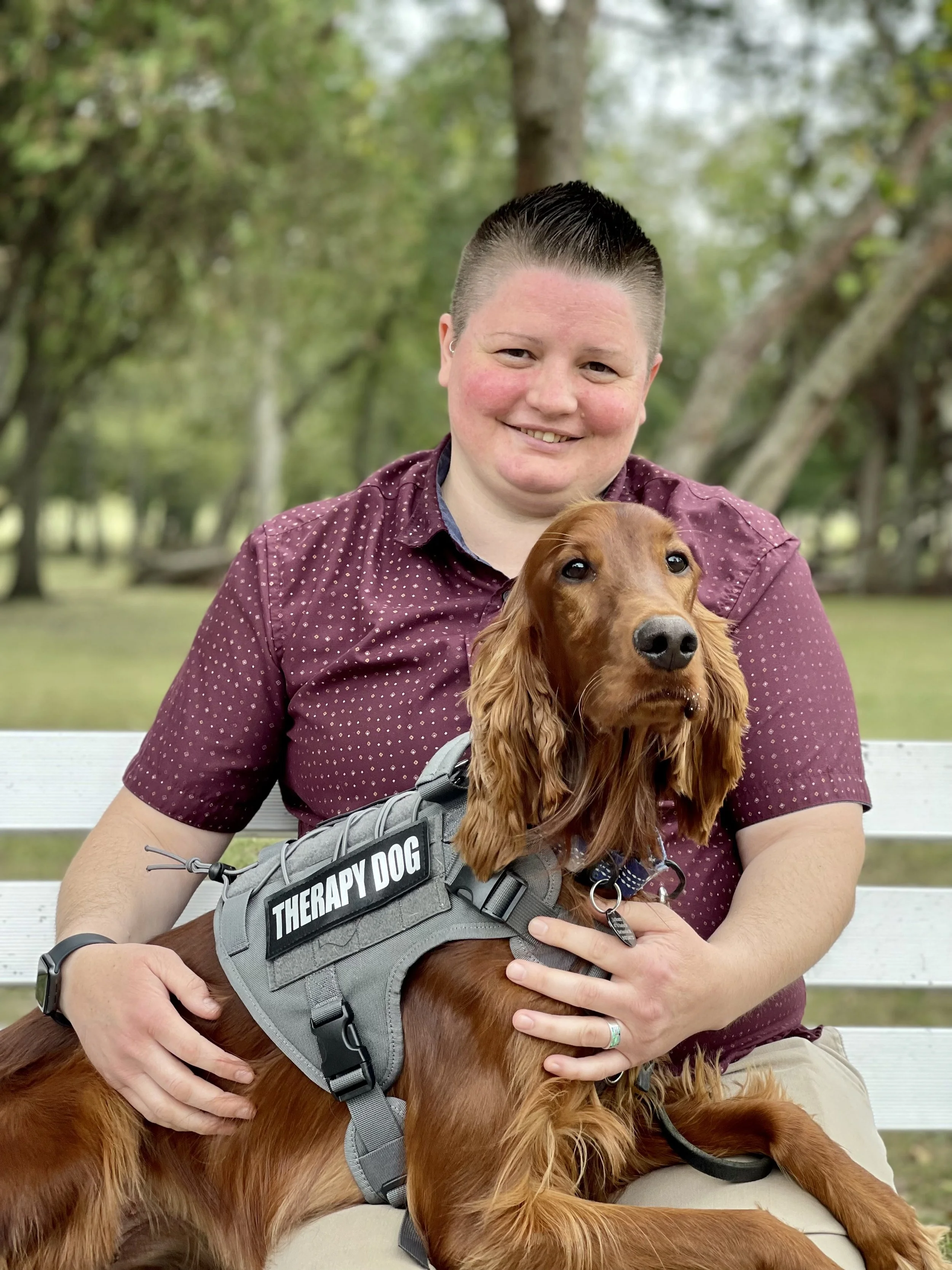 Elizabeth Krantz, LPC — therapist at Exhale Counseling's Downtown Tulsa location, pictured with Ari, her certified canine therapy animal