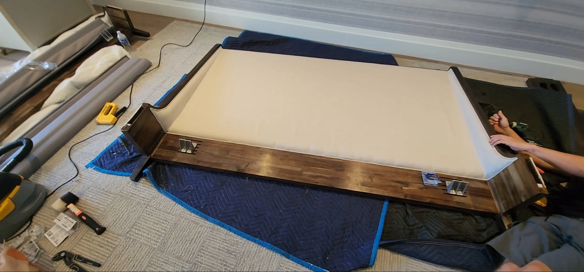 Oversized headboard carefully maneuvered through tight hallway