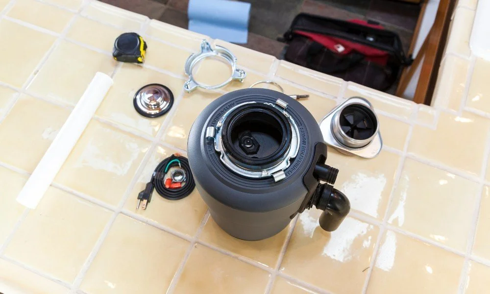 Disassembled scuba diving regulator and accessories on a tiled surface.