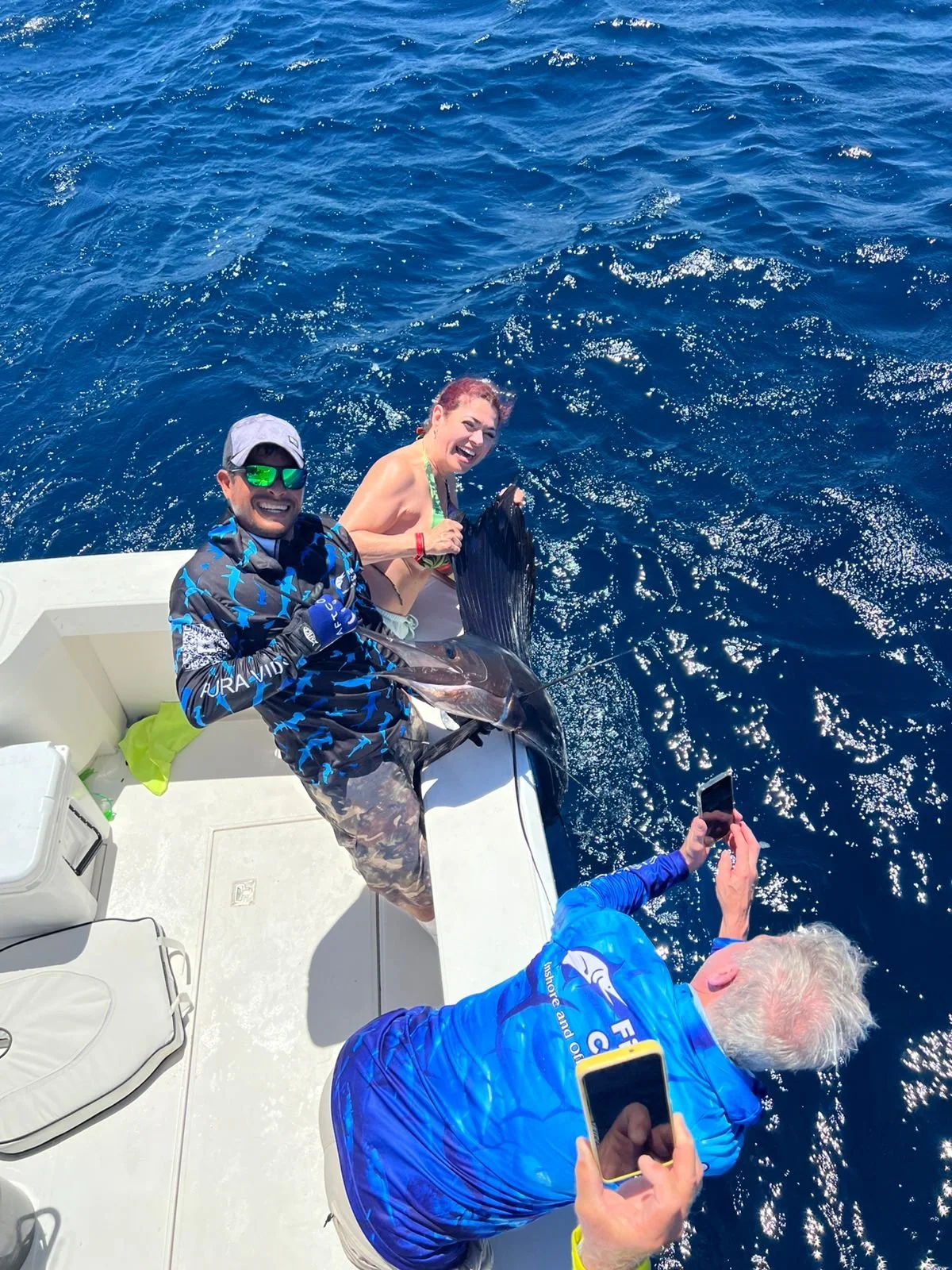 Fish Tale 2 1st Mate Nesmer, Landing a large Sailfish on the Fish Tale 2, private fishing charters out of Marina Flamingo, located in Playa Flamingo, Guanacaste, Costa Rica