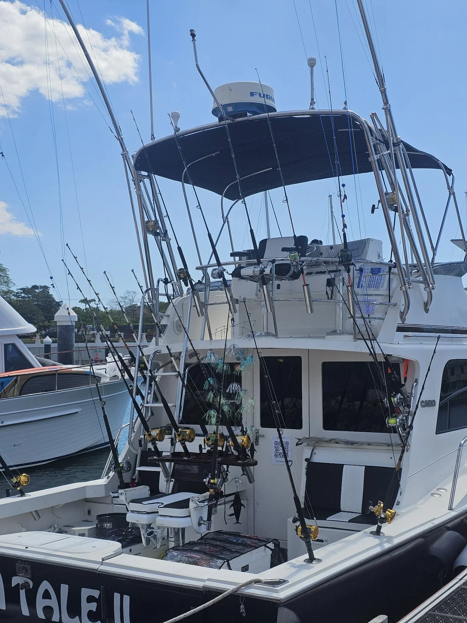 Fish Tale 2 fishing charter boat docked at Marina Flamingo Costa Rica with full rod setup ready for offshore fishing