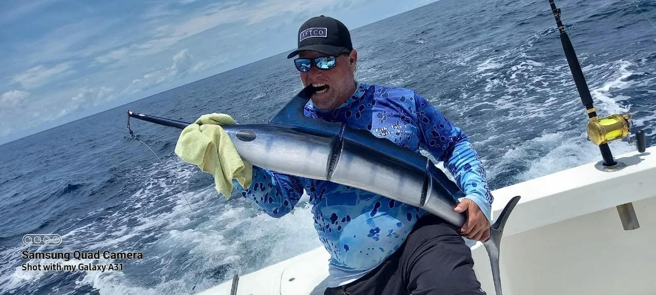 Mate Sean holding a MarlinX lure aboard Fish Tale 2 fishing charter in Guanacaste Costa Rica