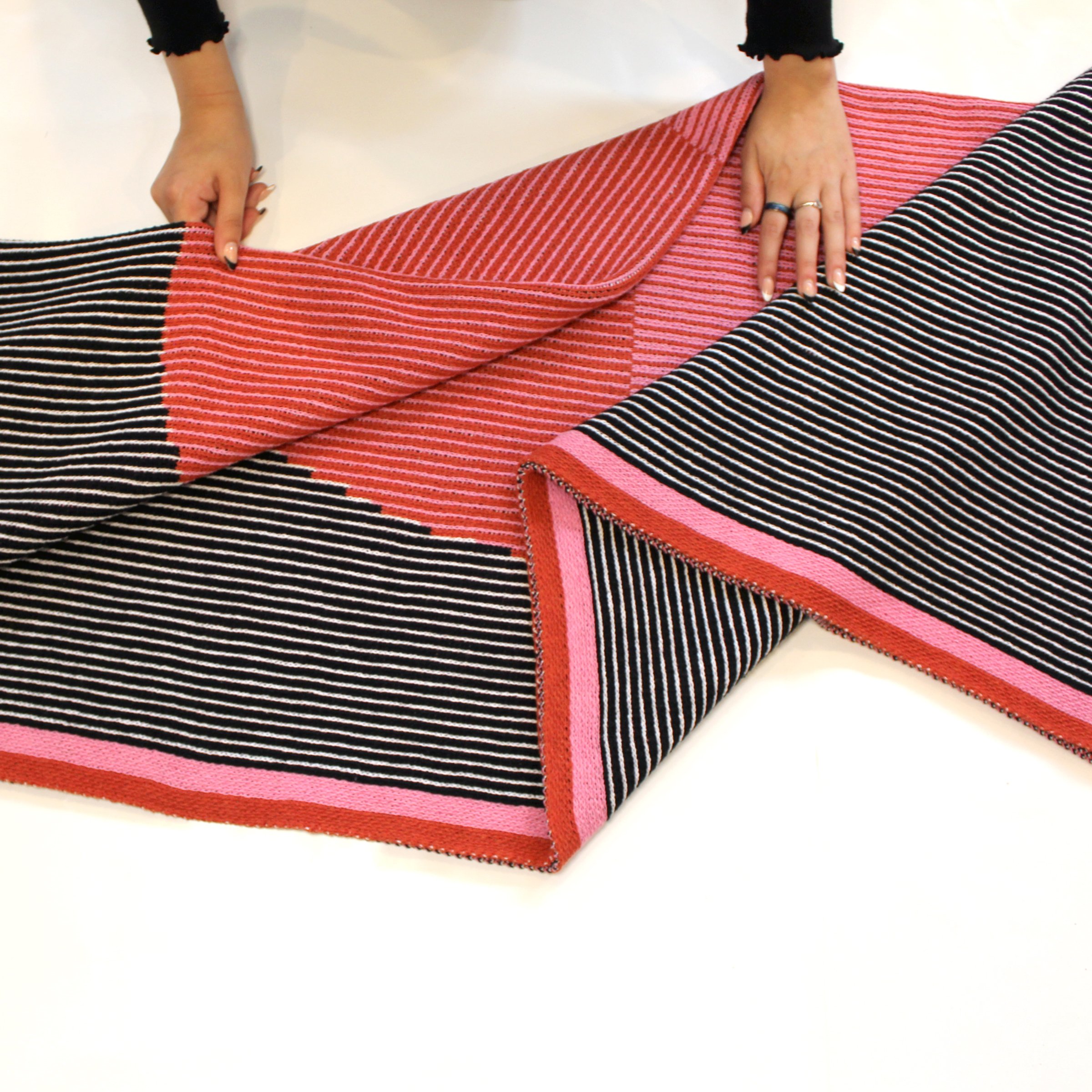 Mega Dot Throw Blanket with Big Red and Pink dot in the center and a black and white background