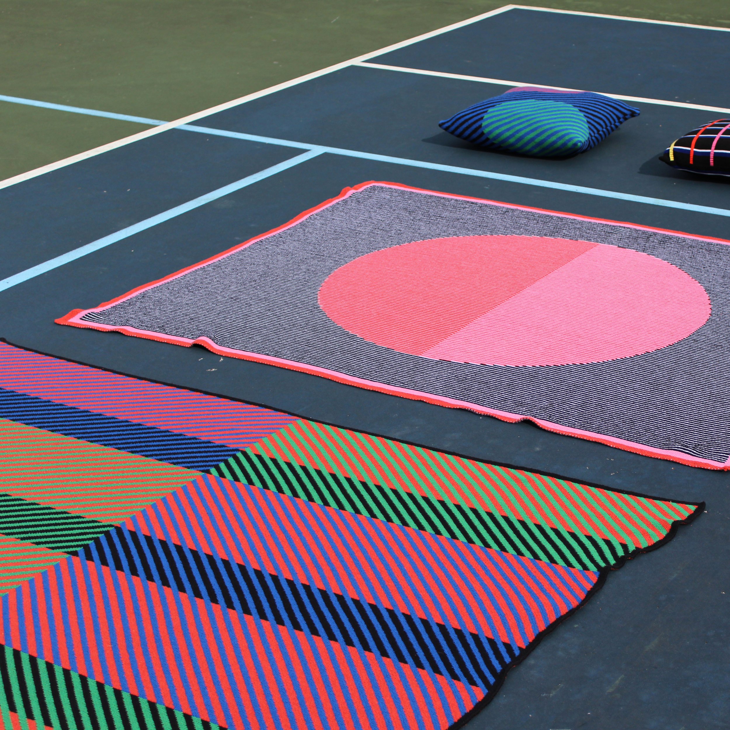 Mega Dot Throw Blanket with Big Red and Pink dot in the center and a black and white background