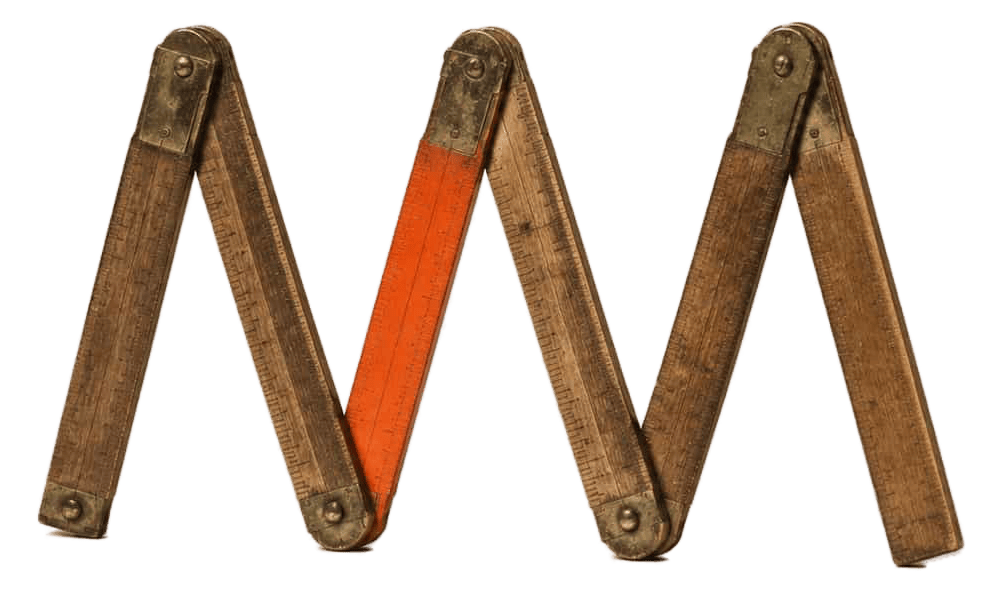 Antique brass-hinged wooden folding ruler opened into a zigzag, one segment painted bright orange, standing on cream paper