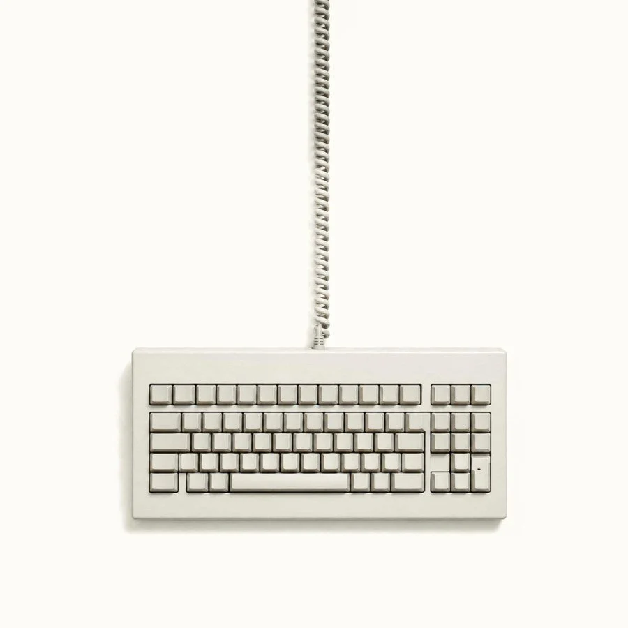 Beige keyboard with coiled cable: Tocobaga marketing for professional services firms