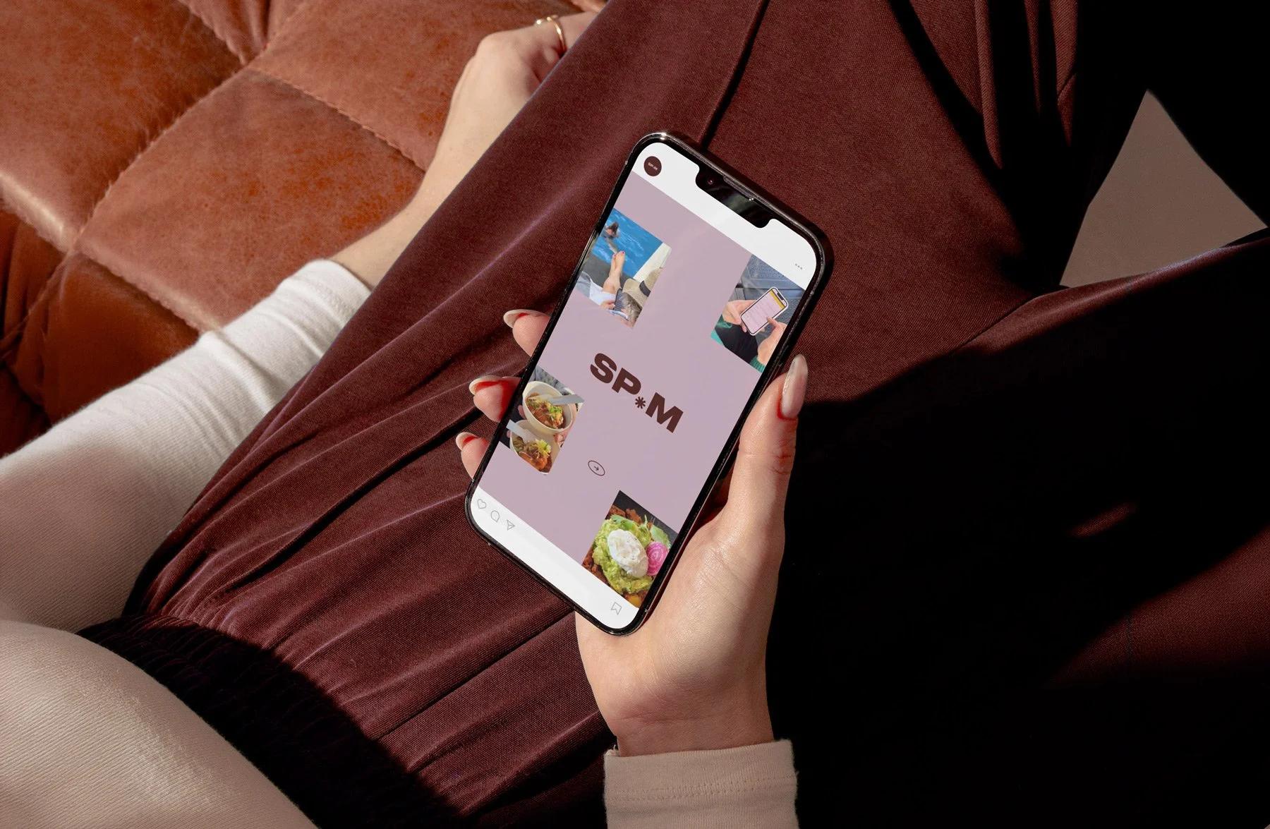 Woman holding a mockup of a marketing agency brand on a mobile phone.