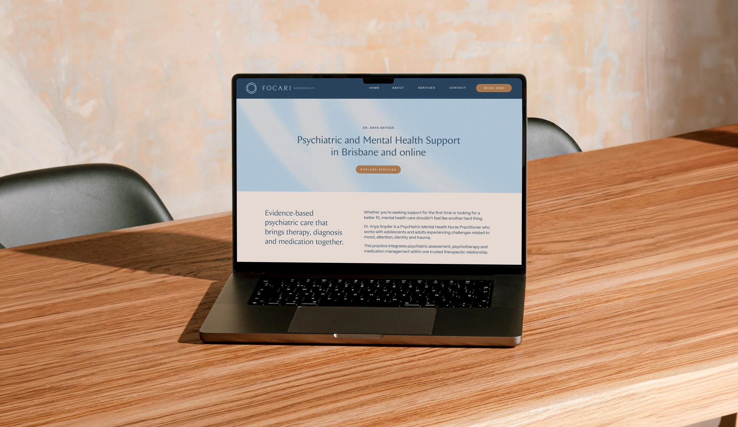 Website sitting on office table with mockup of a website by Foster Creative.