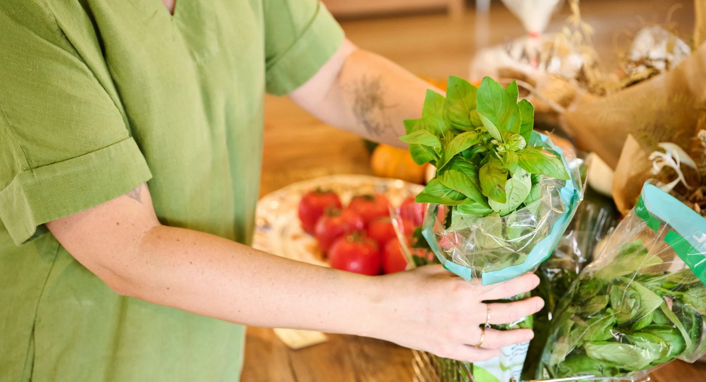 Close up of hands holding basil as part of a photoshoot for a Brisbane nutritionist.