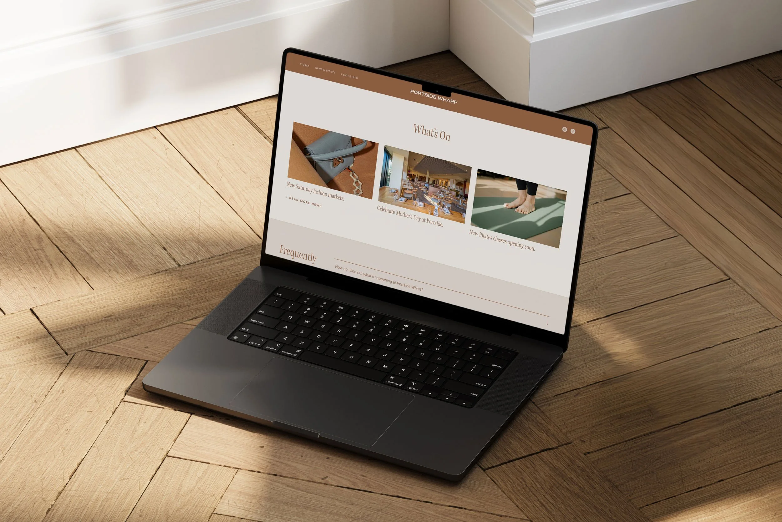 Mockup of a retail website on a laptop sitting on the floor.