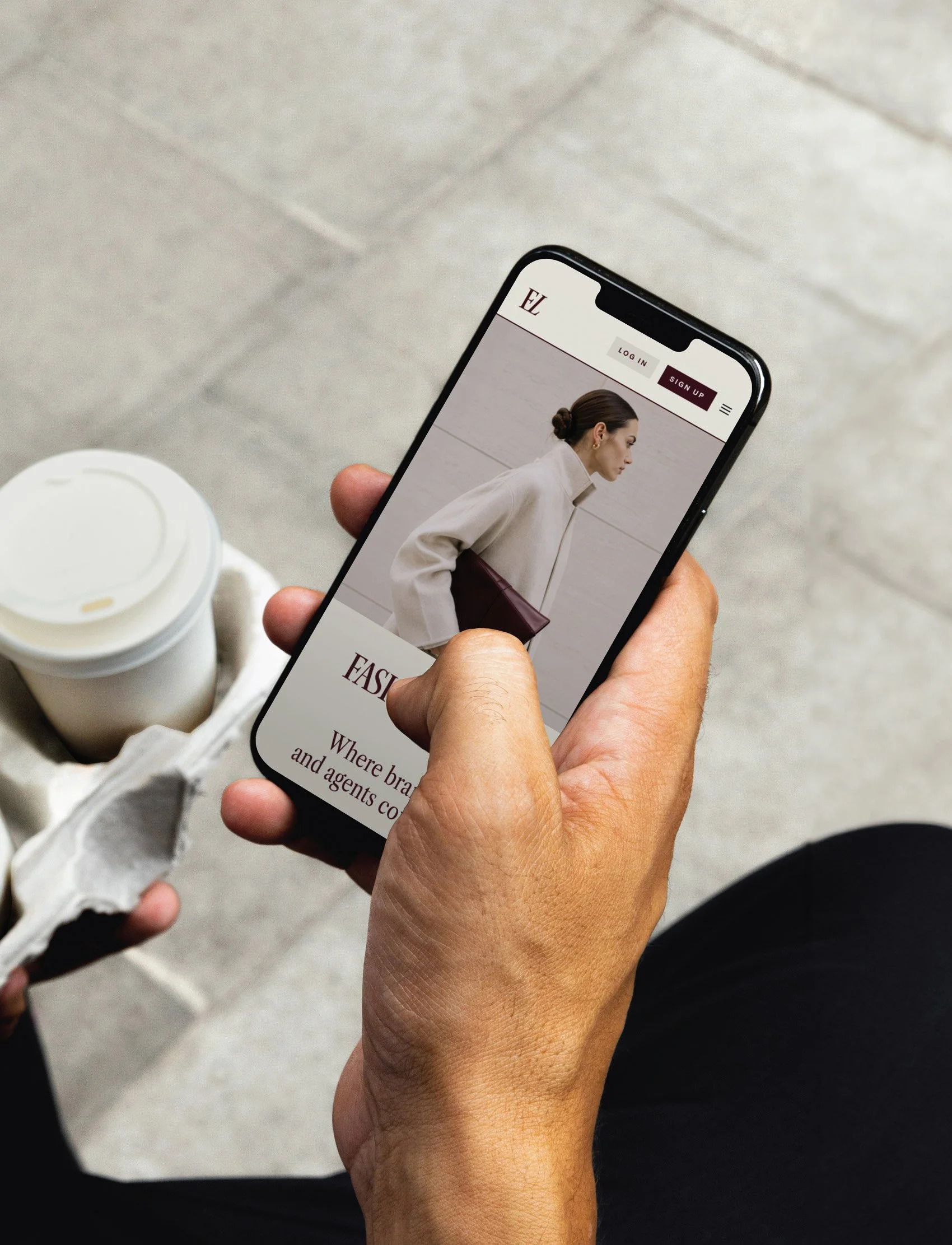 Mobile phone showing fashion app branding