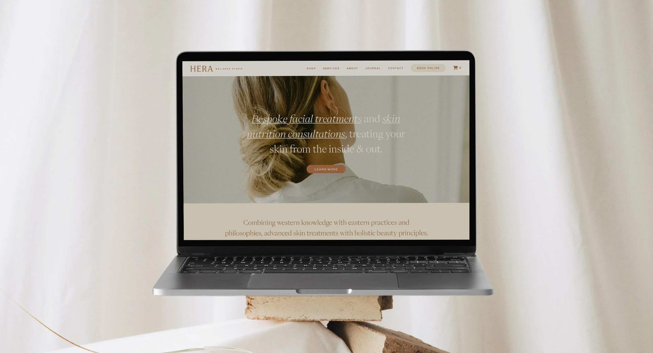Laptop displaying a wellness brand website designed by Foster Creative