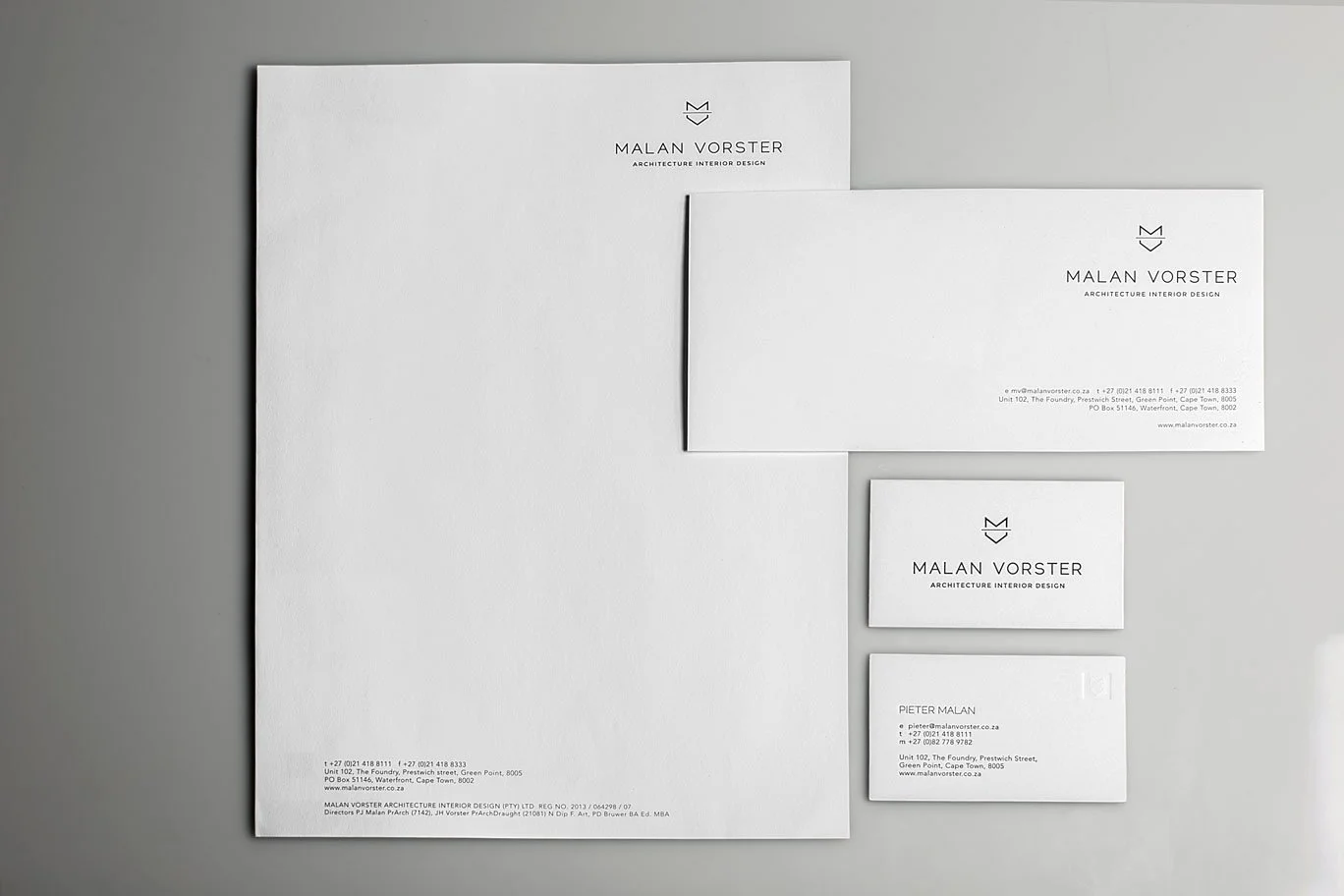 Set of branded business stationery including a large letterhead, two smaller cards, and a business card for Malan Vorster. All are on a light gray background.