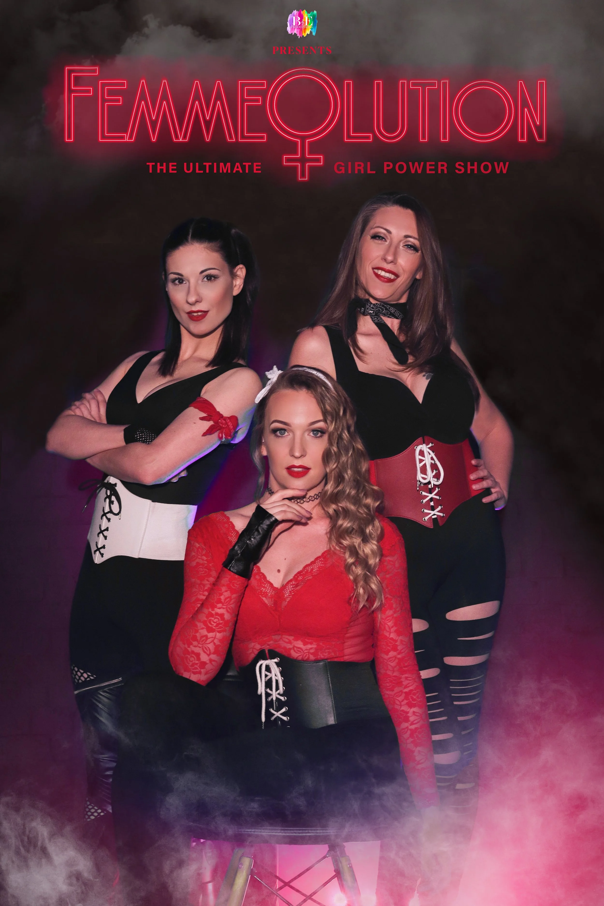Three girls posing in a dark, red and smokey room