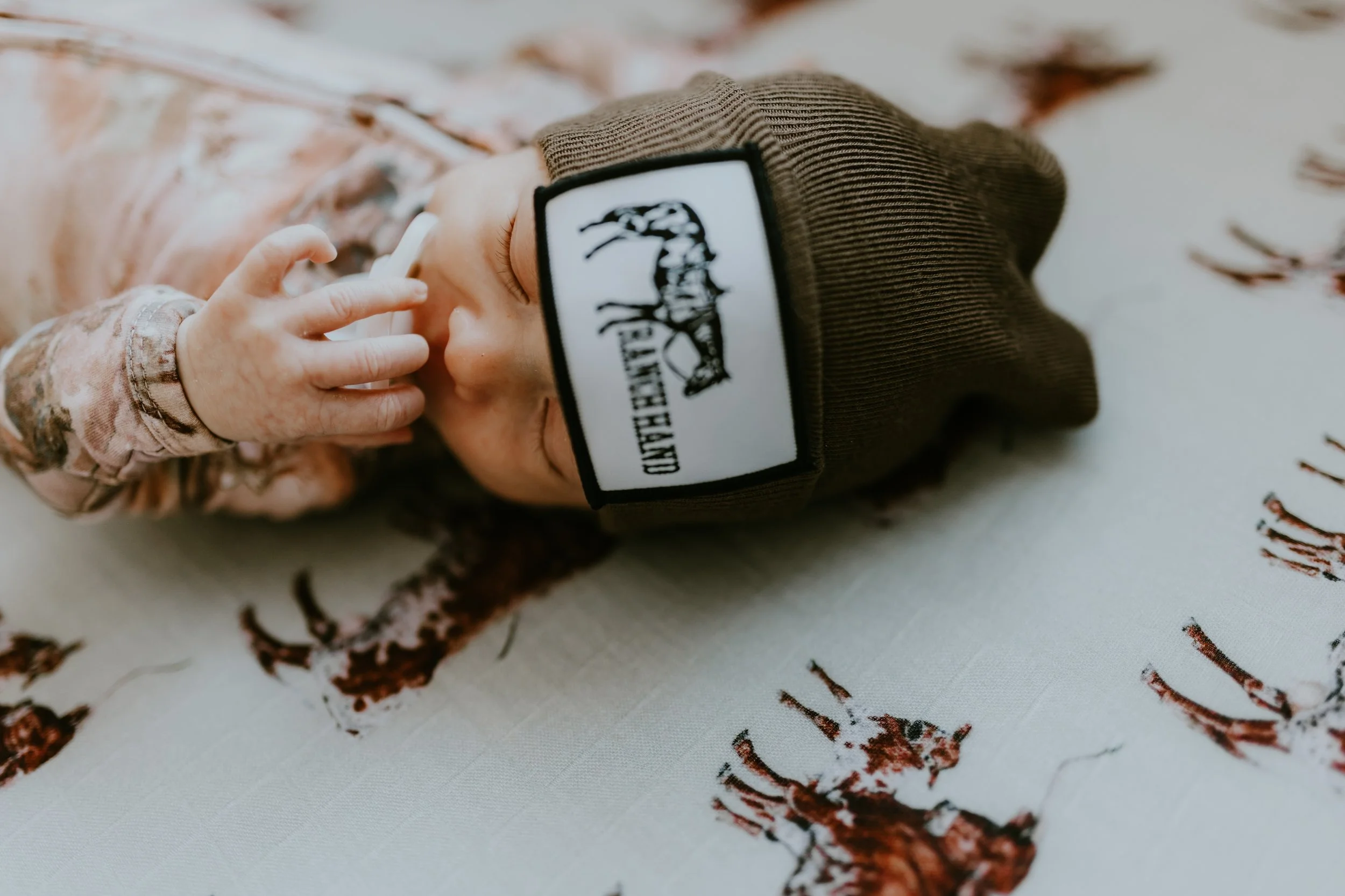 baby boy in crib holding soother