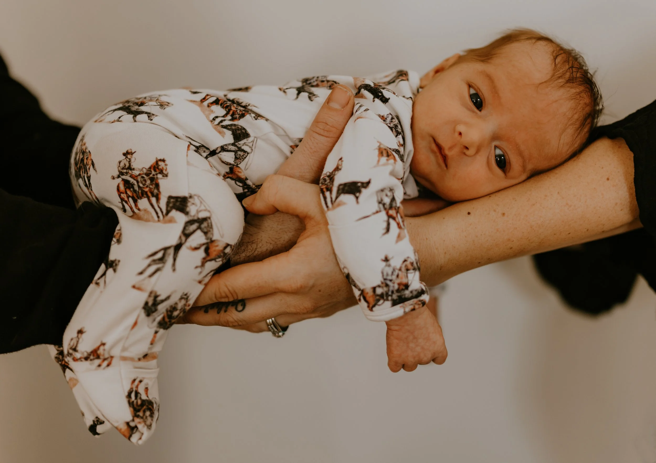 mom and dad holding baby boy