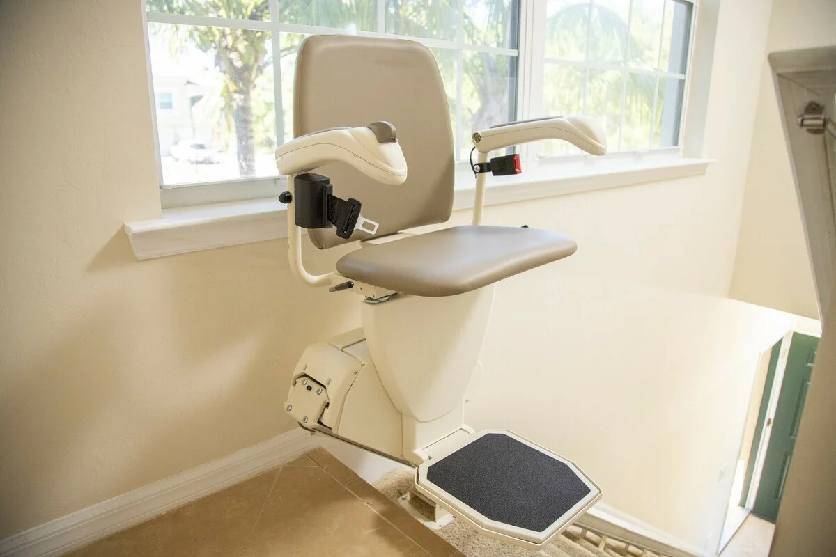 A stair lift in a home with a window.