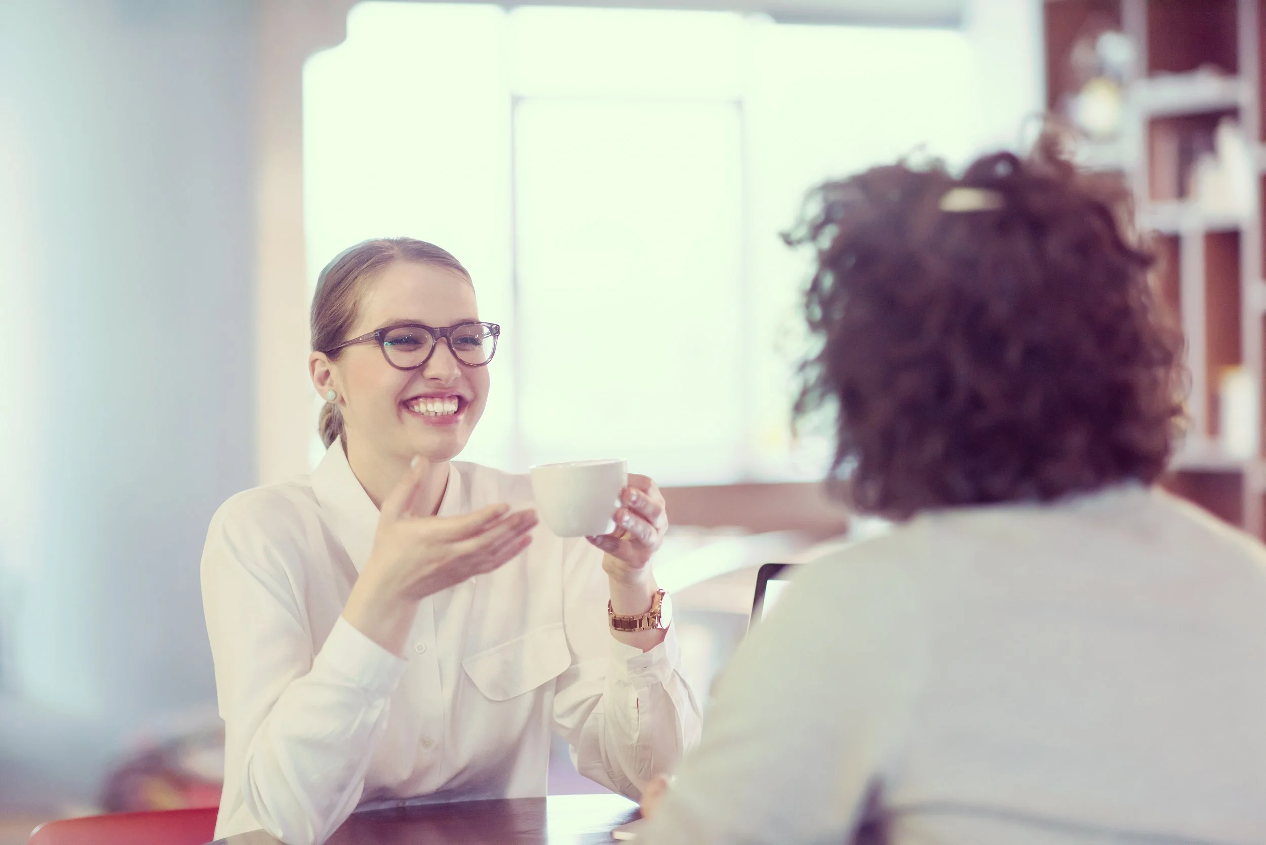 Two women talking over coffee