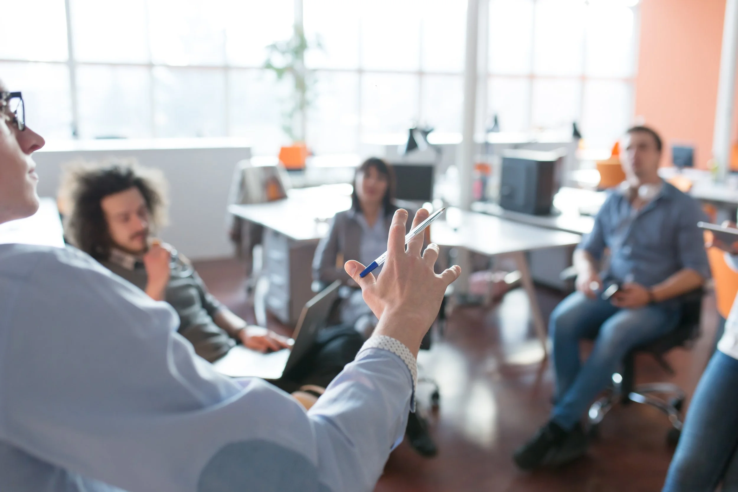 small group of people having a discussion in an office