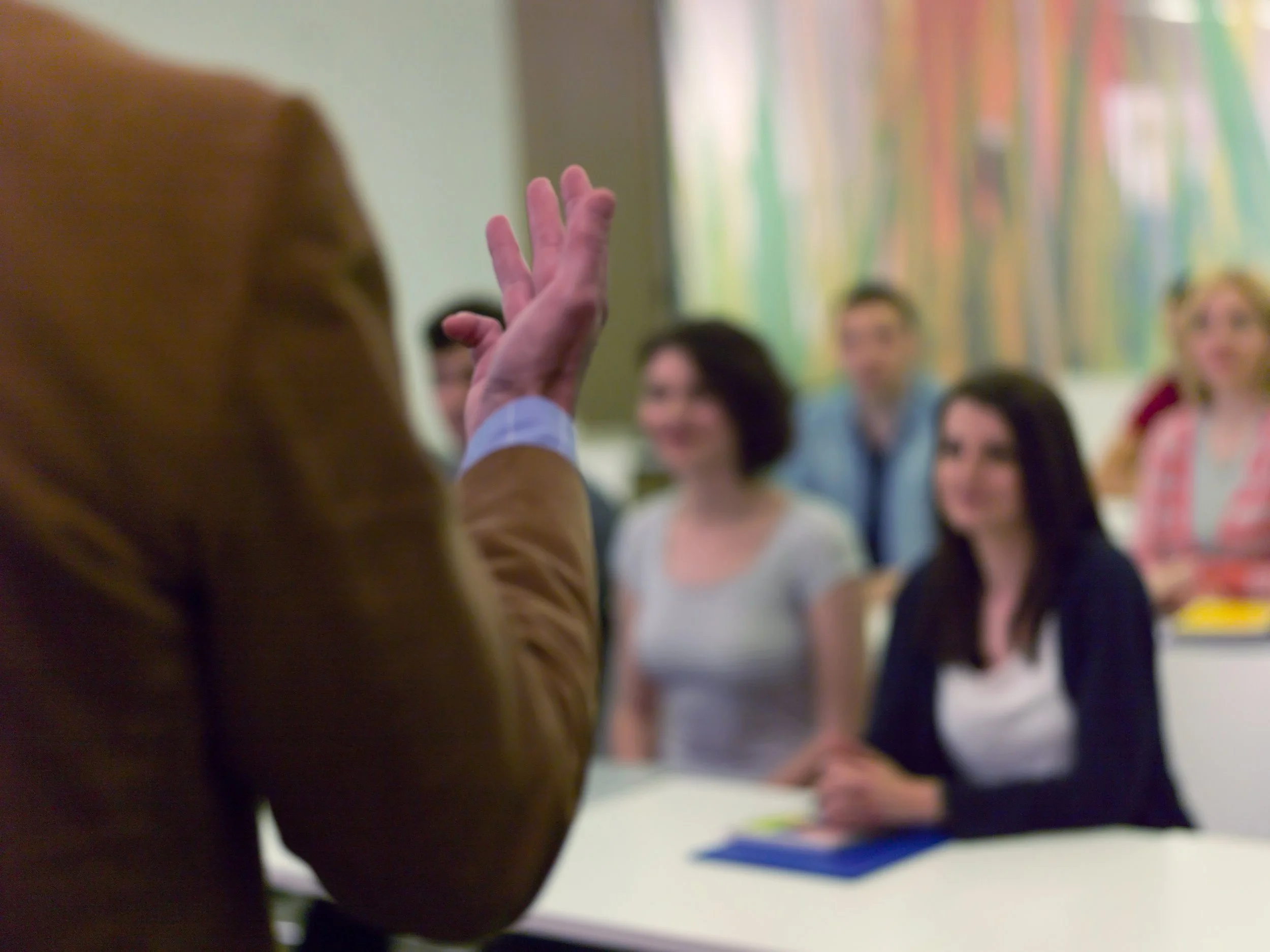 close up of presenters hand in a small group seminar