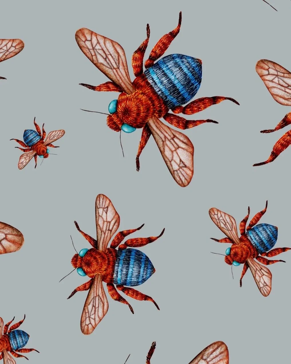 Close up shot of hand-painted bee artwork showing detailed bees with blue-banded bodies and translucent wings scattered across a pale blue background.