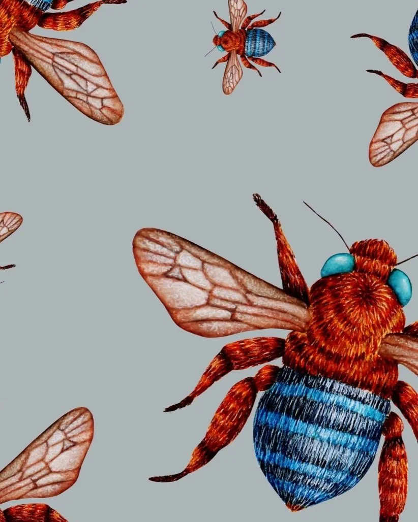 Close up shot of hand-painted bee artwork showing detailed bees with blue-banded bodies and translucent wings scattered across a pale blue background.