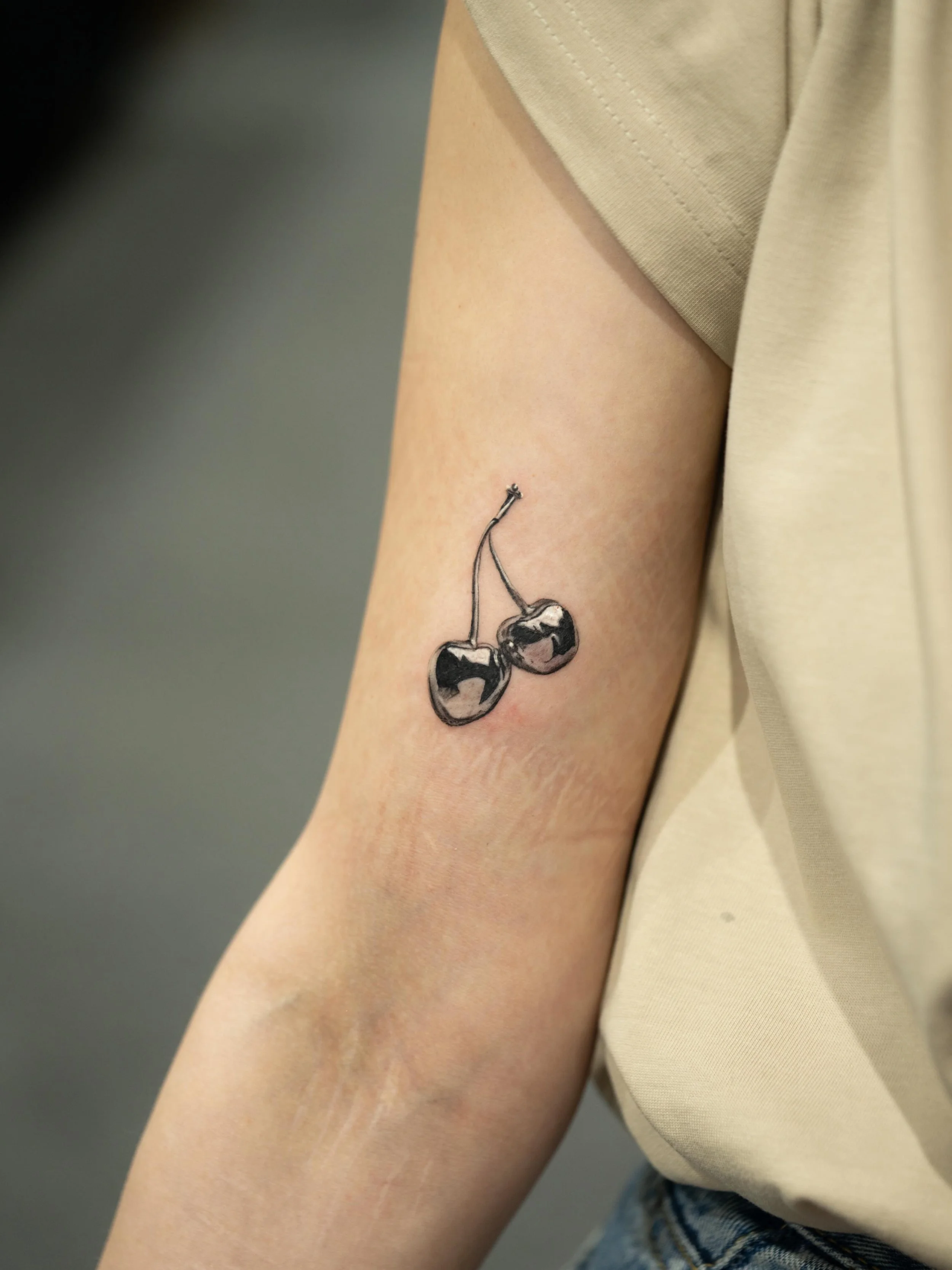 Couple of chrome cherries done at @uktta a little while ago 
.
#chrometattoo #metallictattoo #shineytattoo