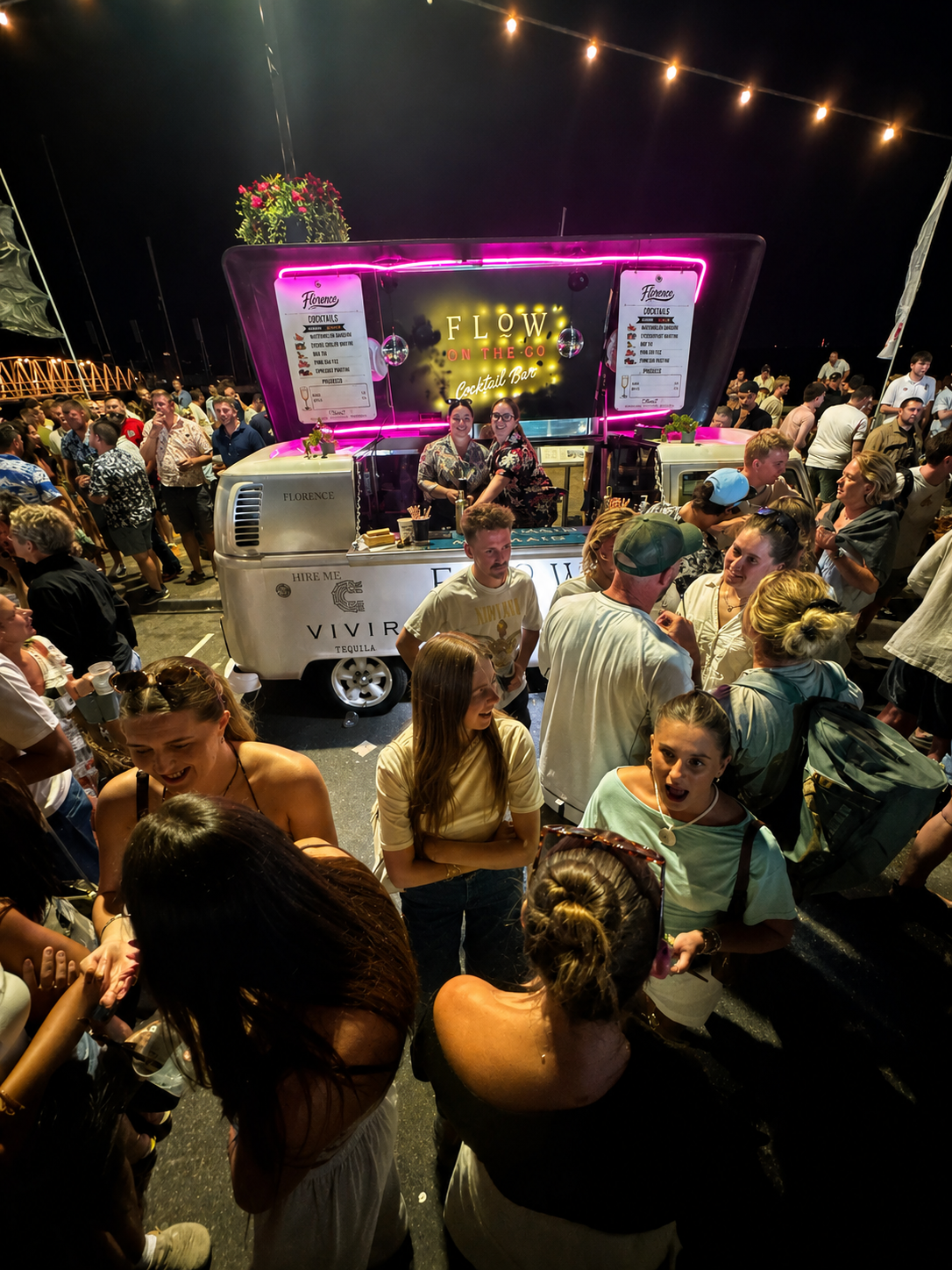 Guests enjoying cocktails around the Florence vintage VW cocktail bar at an evening event