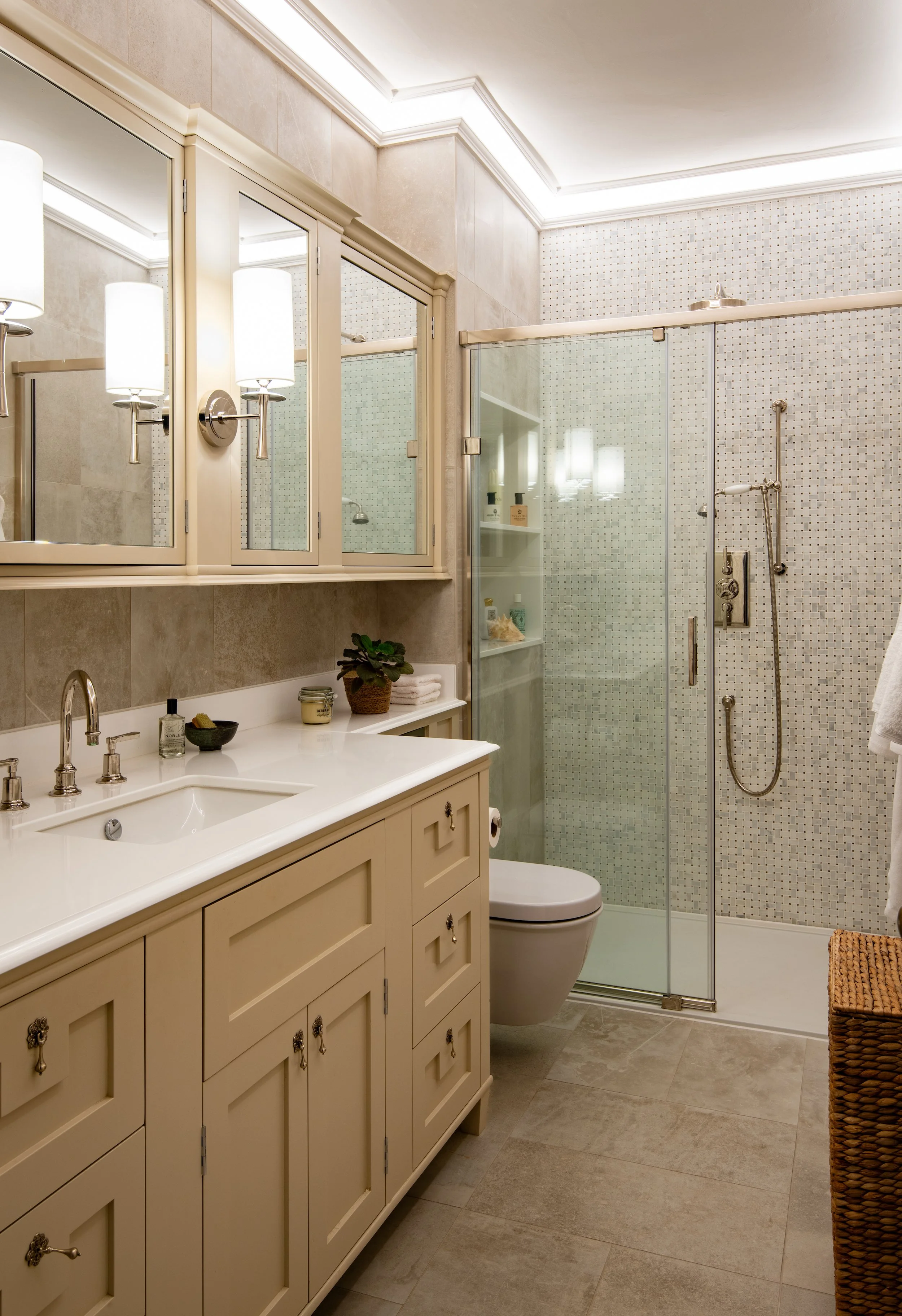 Children’s en-suite shower room designed by MIDA Interiors for a large Cotswolds country estate, created by reconfiguring an adjoining bedroom and featuring bespoke vanity cabinetry, mirrored storage, a generous walk-in shower, integrated lighting wi