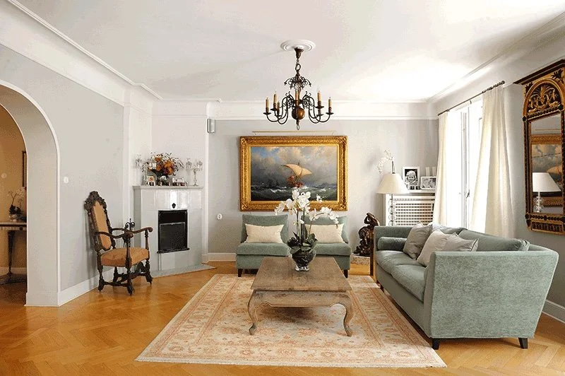 Luxury apartment salon in Stockholm designed by MIDA Interiors, featuring elegant period detailing, curated antiques, bespoke upholstery, parquet flooring and a refined neutral palette.