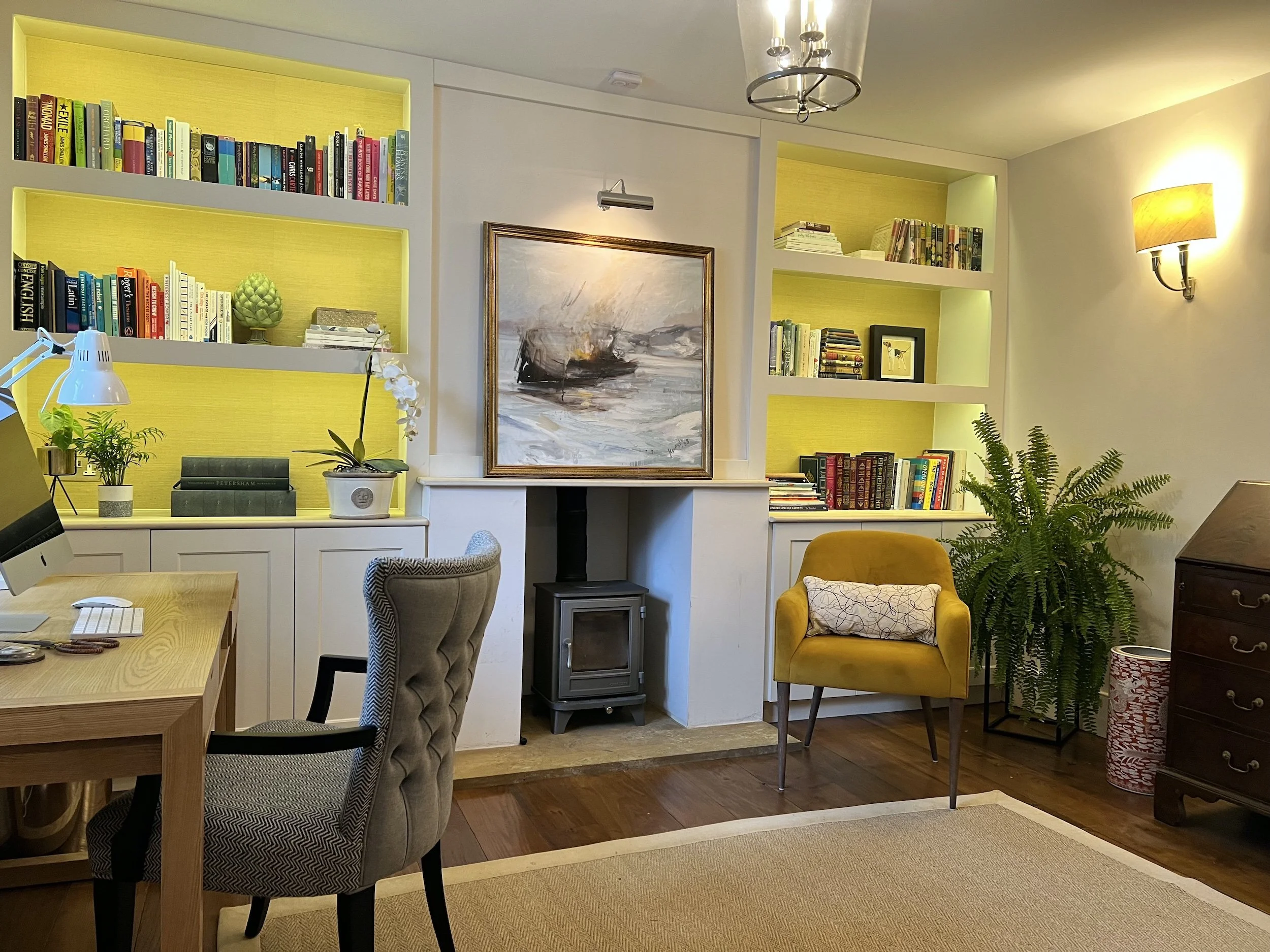 Bespoke two-person study in a 19th-century Oxfordshire cottage, featuring illuminated grasscloth-backed joinery, reclaimed oak flooring, stone surfaces and a new log burner.