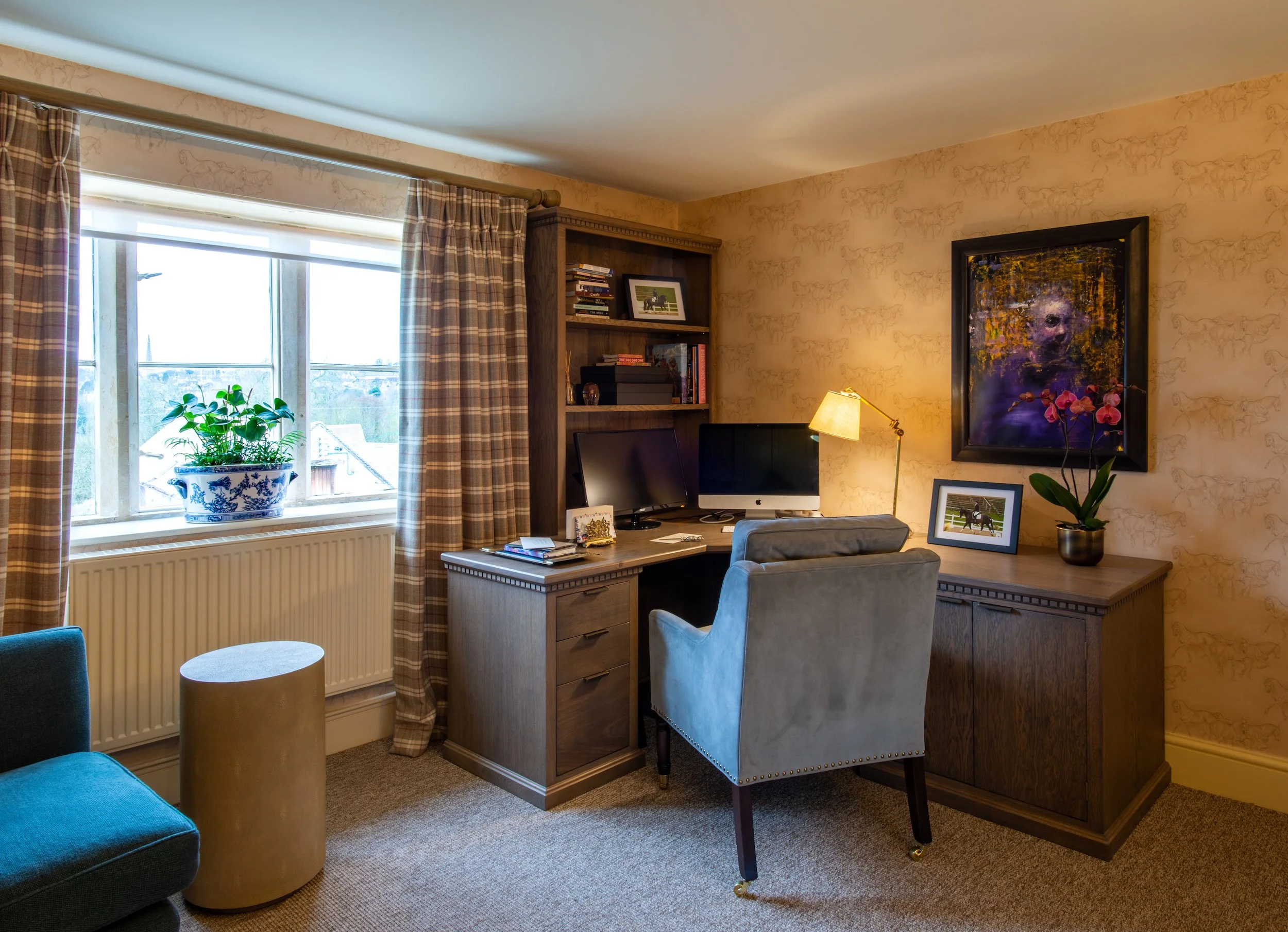 A private study within a Grade II listed Cotswold farmhouse, centred on a bespoke L-shaped desk designed and handcrafted around the owners’ working requirements. Integrated cabinetry and shelving create an organised dual-screen workspace, while eques