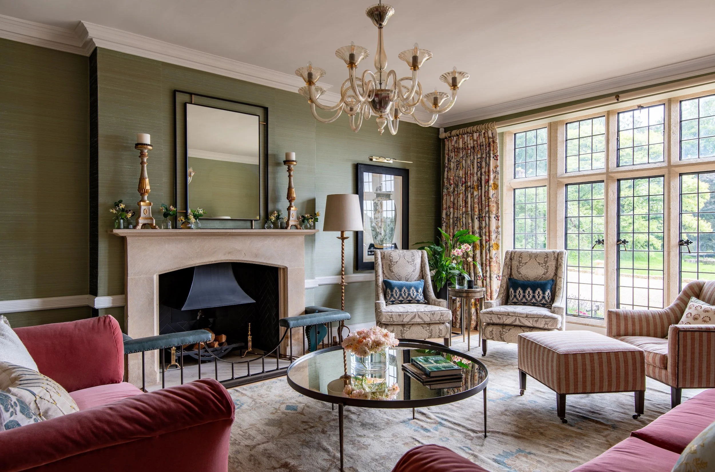 Luxury drawing room by MIDA Interiors in a large Cotswolds country estate, featuring period architecture, bespoke furnishings, layered textiles and confident colour.