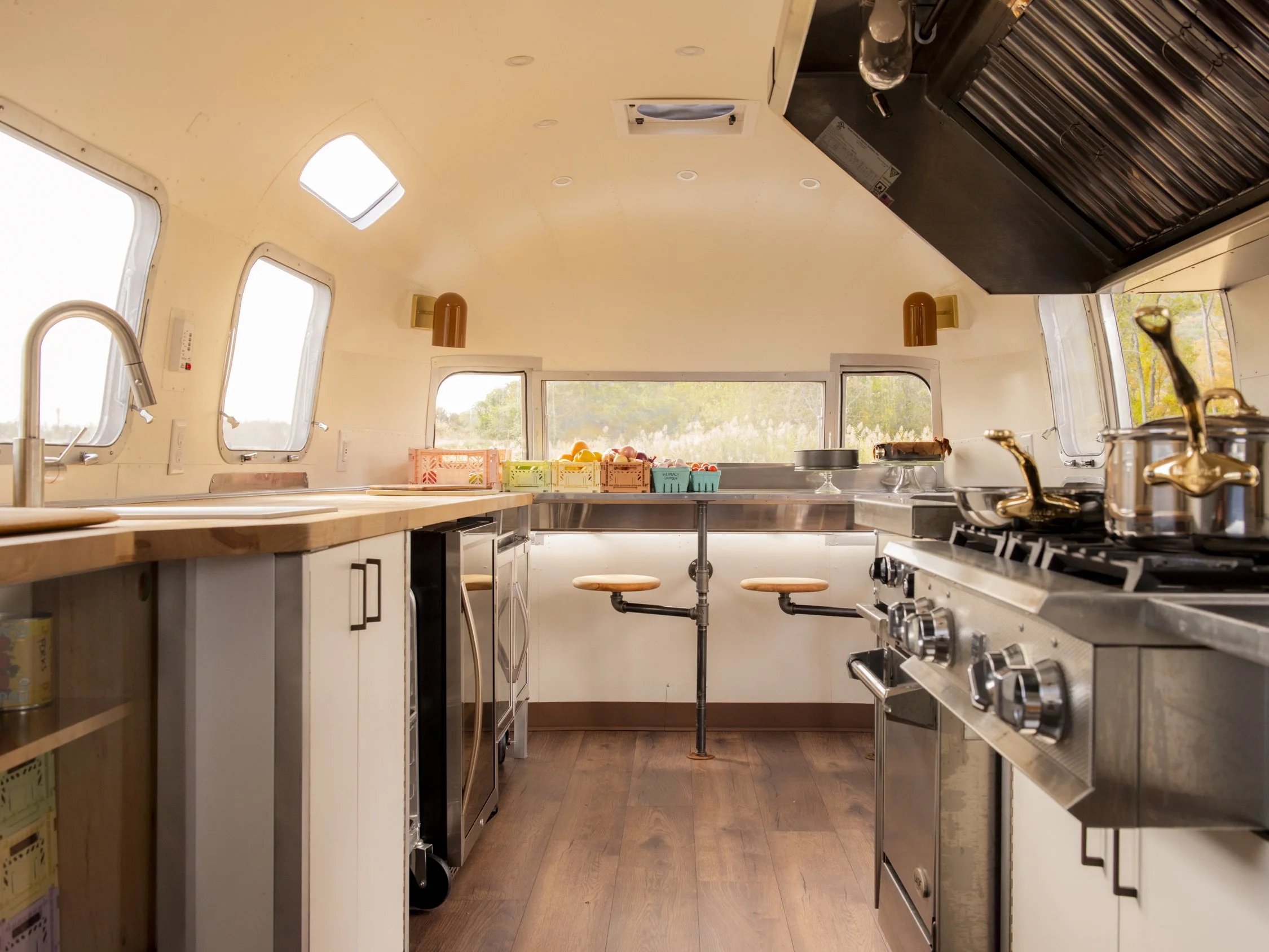 Interior image of Westerly Canteen's airsream kitchen. Sun drenched with colorful restaurant ingredients on the counter.