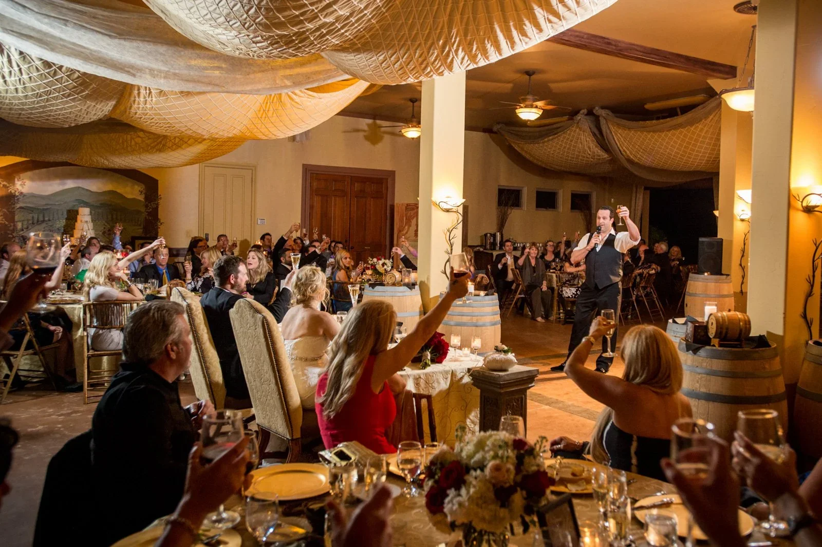 Romantic wineries in Temecula at Gershon Bachus Vintners barrel room wedding with warm lighting