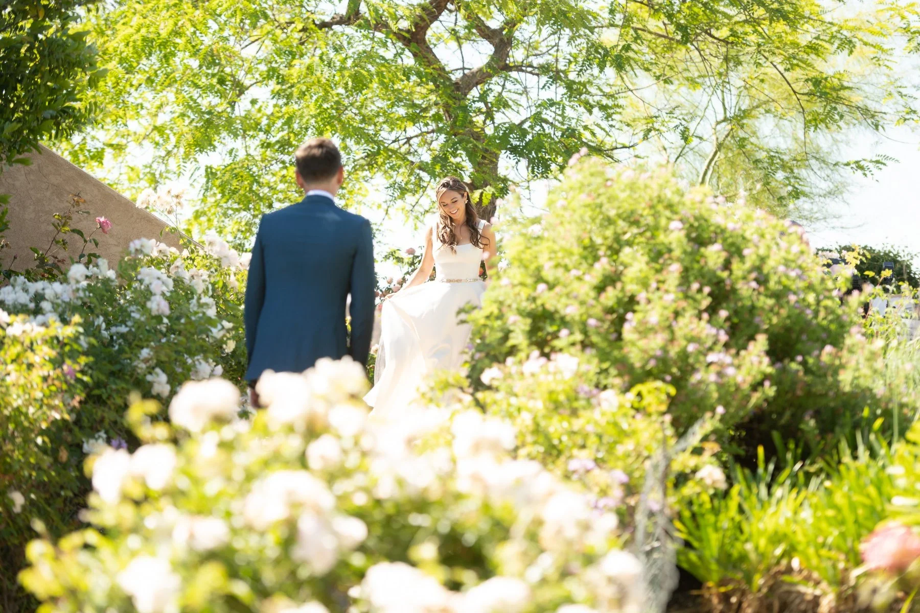 Romantic wineries in Temecula at Gershon Bachus Vintners bride and groom first look rose garden