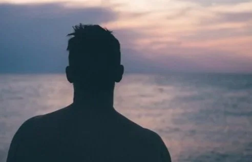 A silouette of a man at sunset