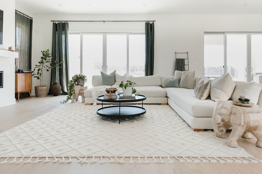 Neutral, warm living room home with dark green accents.