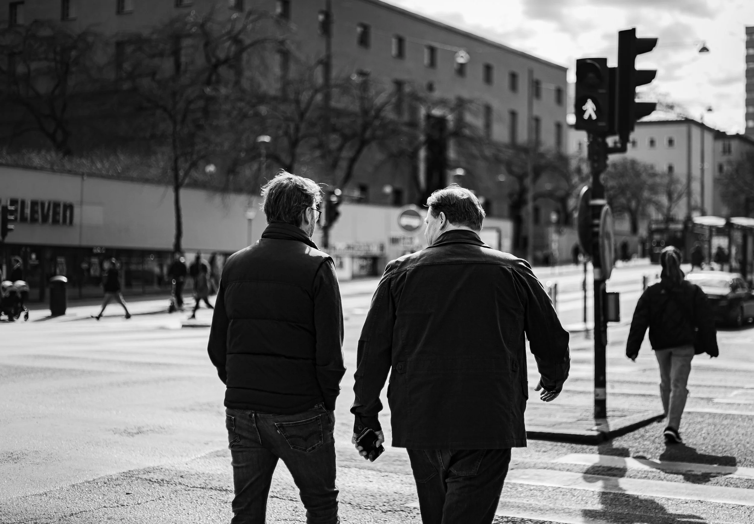 two middle aged men walking on a street