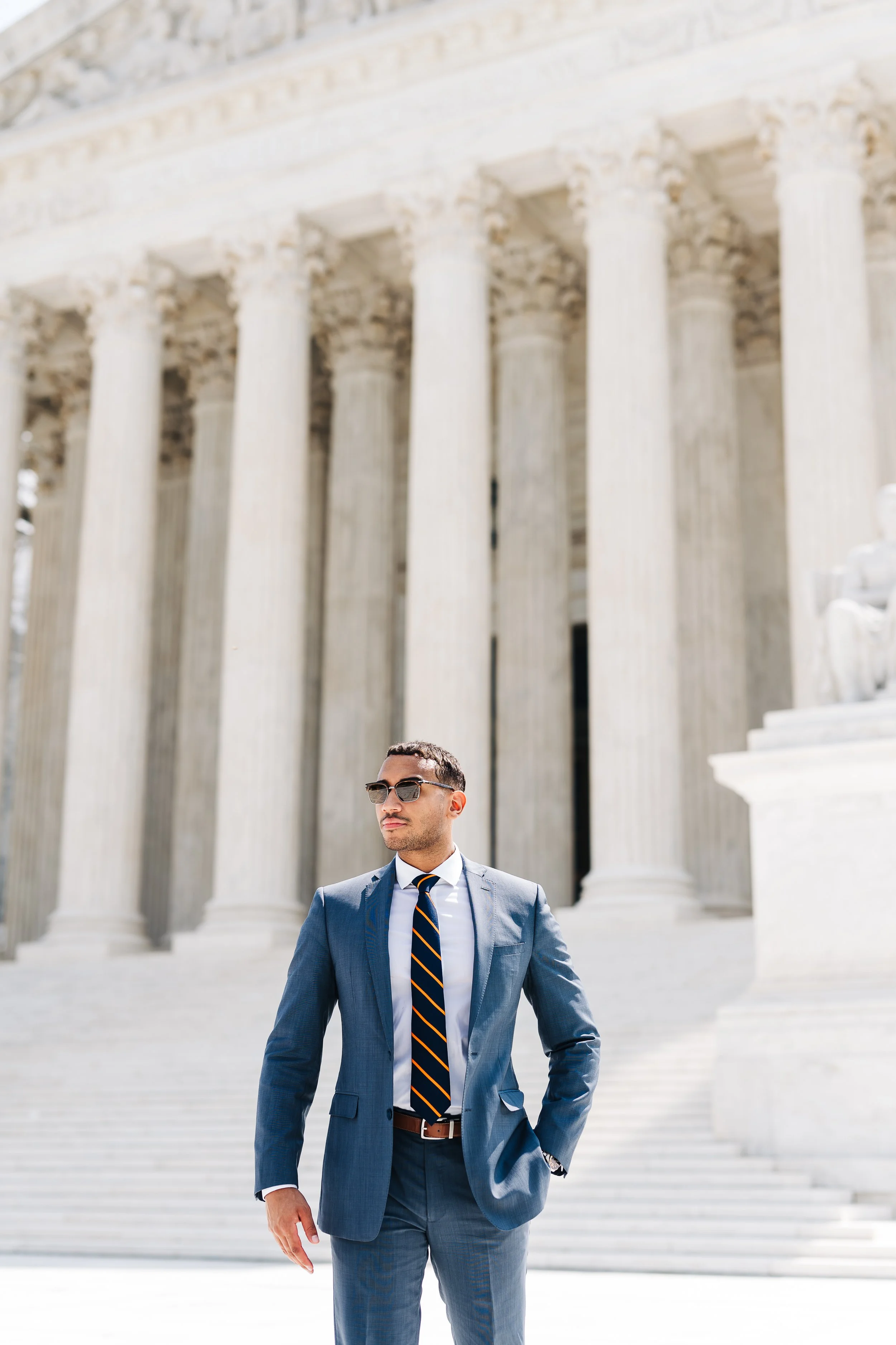 Graduation photo of man in front of SCOTUS
